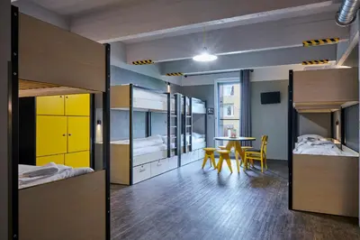 a room with bunk beds and a table and chairs at MEININGER Hotels Bruxelles City Center in Brussels