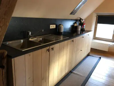 a kitchen with a sink and a counter top at Trommelhoeve Farm Lofts in Boechout