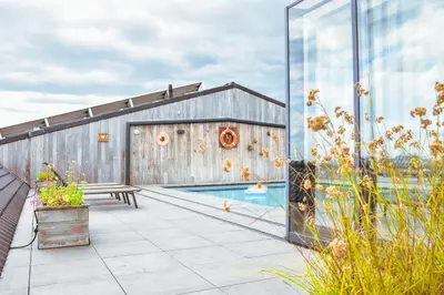 a patio with a pool and a building at B&B Fruithof Tack in Sint-Gillis-Waas