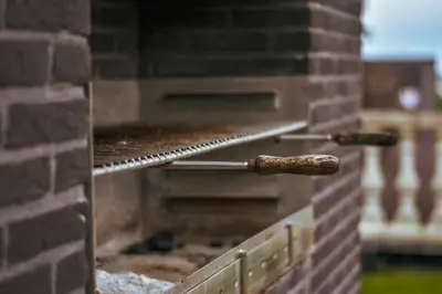 a brick oven with two cooking utensils on it at B&B Fruithof Tack in Sint-Gillis-Waas