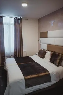 a bedroom with a large bed in a room at Hôtel onyx expo in Brussels