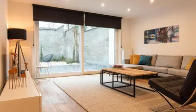 a living room with a couch and a table at House Forelle Gent in Ghent