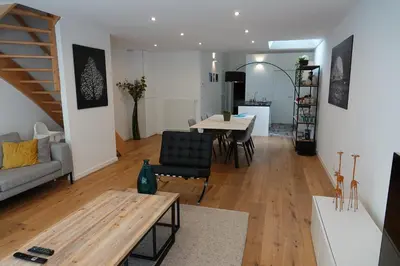 a living room with a table and a dining room at House Forelle Gent in Ghent