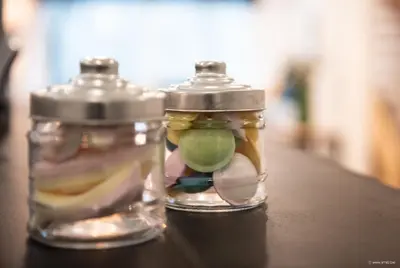 two glass jars with food in them sitting on a table at House Forelle Gent in Ghent
