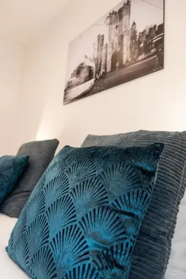 a blue pillow sitting on top of a bed at House Forelle Gent in Ghent