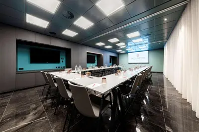 a conference room with a long table and chairs at NH Collection Antwerp Centre in Antwerp