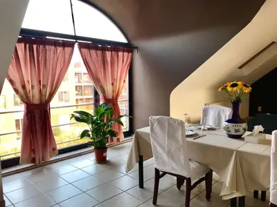 a dining room with a table and a large window at FANTASIA a spacious beautiful apartment & affordable in Nossegem