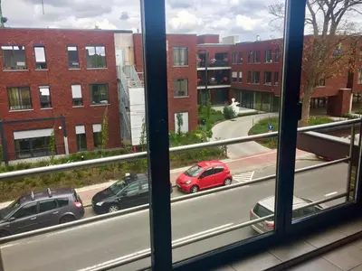 a view from a window of cars on a city street at FANTASIA a spacious beautiful apartment & affordable in Nossegem