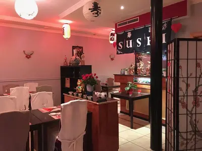 a restaurant with white chairs and a sign that reads sushi at FANTASIA a spacious beautiful apartment & affordable in Nossegem