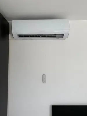 a white air conditioner on top of a ceiling at FANTASIA a spacious beautiful apartment & affordable in Nossegem