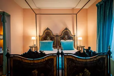 a bed in a room with a large mirror at Charme Hotel Hancelot in Ghent