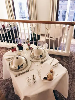 a white table with plates and silver dishes on it at Steigenberger Icon Wiltcher's in Brussels