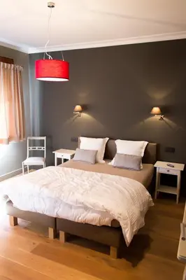 a bedroom with a large bed with a red ceiling at Mon Dieu in Scherpenheuvel-Zichem