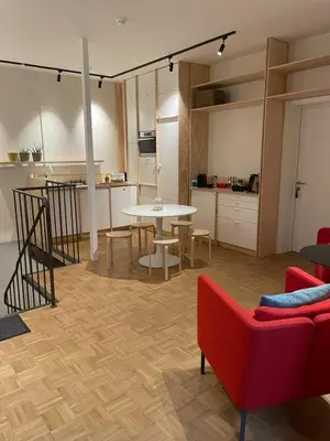 a living room with a red couch and a table at Violet Suites in Ghent