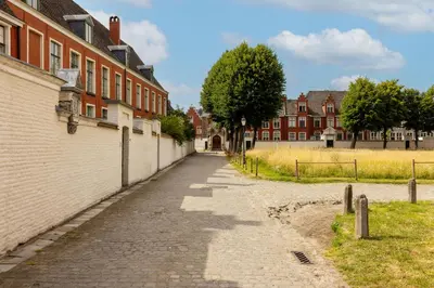 an empty street in a town with brick buildings at Violet Suites in Ghent