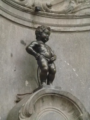 a statue of a little boy on top of a building at Hotel Chantecler in Brussels