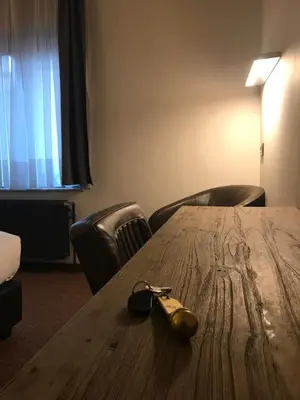 a wooden table with a pair of glasses on top of it at Hotel Chantecler in Brussels