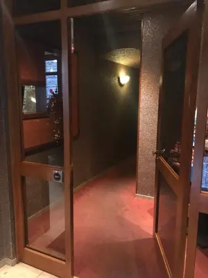 an open glass door in a room with a hallway at Hotel Chantecler in Brussels