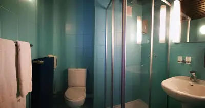 a bathroom with a toilet and a sink at Hotel Chantecler in Brussels