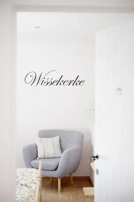a living room with a couch and a sign that reads misfire at Vakantiewoning De Gulden Sleutels in Kruibeke