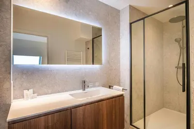 a bathroom with a sink and a mirror at Marriott Executive Apartments Brussels in Brussels