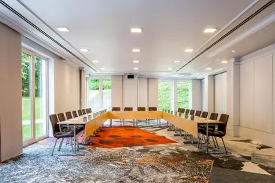 a conference room with a long table and chairs at Marriott Executive Apartments Brussels in Brussels