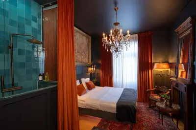 a bedroom with a bed and a chandelier at Spirella in Brussels
