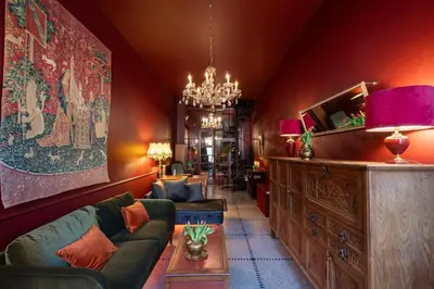 a living room with a couch and a chandelier at Spirella in Brussels
