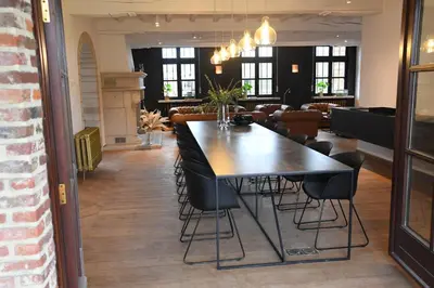 a dining room with a table and chairs at Ask Lily in Westmeerbeek