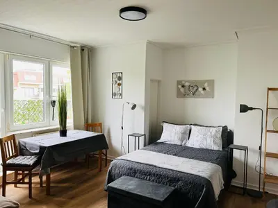a bedroom with a bed and a table and a window at Studio Brussels Expo in Brussels