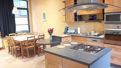 a kitchen with a table and a dining room at CEP MAISONNETTE in Brussels