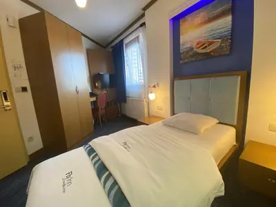 a hotel room with a bed and a painting on the wall at Fly inn Hotel Lounge & Nezzo Restaurant in Machelen