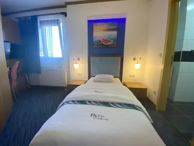 a bedroom with a large bed in a room at Fly inn Hotel Lounge & Nezzo Restaurant in Machelen