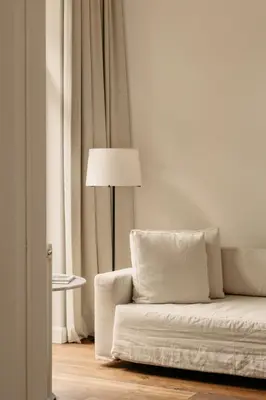 a living room with a white couch and a lamp at august in Antwerp