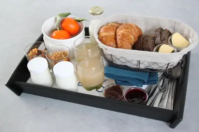 a tray of food with bread and other food items at Chez Spoons B&B in Bossut-Gottechain