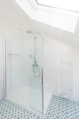 a shower with a glass door in a bathroom at Chez Spoons B&B in Bossut-Gottechain