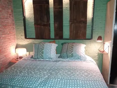 a bedroom with a bed and a mirror on the wall at B&B LoFt 21 in Ravels