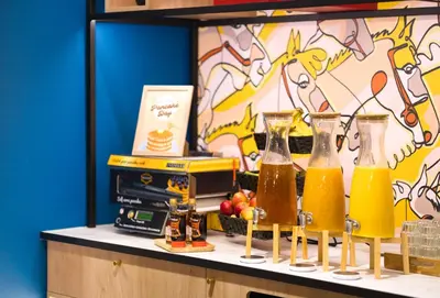 a counter with three vases with drinks on it at B&B HOTEL Brussels Centre Louise in Brussels