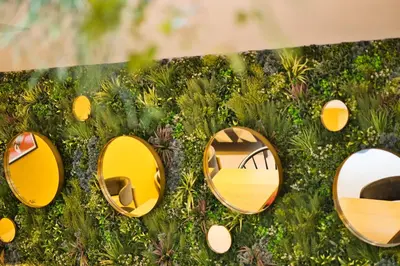 a group of mirrors on the grass with a table at B&B HOTEL Brussels Centre Louise in Brussels