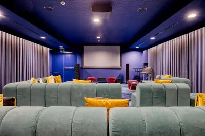 a room with couches and a screen in a room at B&B HOTEL Brussels Centre Louise in Brussels