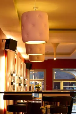 a bar in a restaurant with a ceiling at Hotel De Croone in Ninove