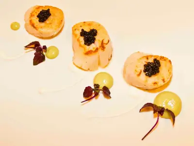 a plate of food with grapes on it at Hotel De Croone in Ninove