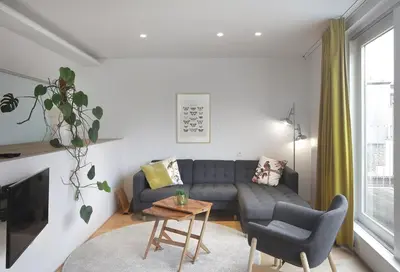 a living room with a couch and a table at Loftsuite in Ghent