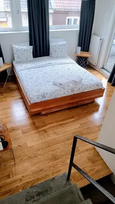 a large bed in a room with a wooden floor at Loftsuite in Ghent