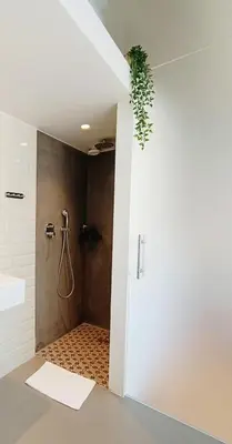 a bathroom with a shower with a shower curtain at Loftsuite in Ghent