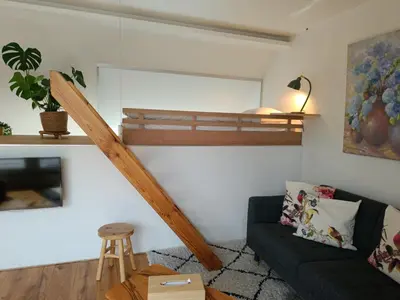 a living room with a bunk bed and a couch at Loftsuite in Ghent