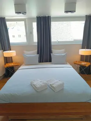 a bedroom with a large bed with two towels on it at Loftsuite in Ghent