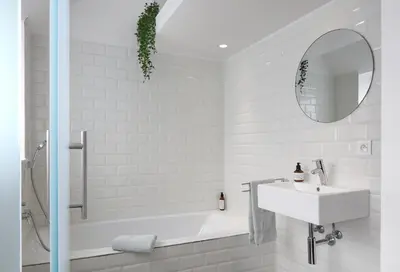 a bathroom with a tub and a sink and a mirror at Loftsuite in Ghent