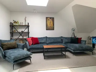 a living room with two couches and a table at Anna Penthouse in Ghent