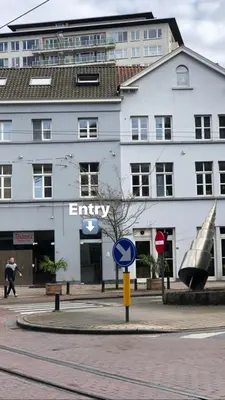 a building with an entry sign in front of a street at Anna Penthouse in Ghent